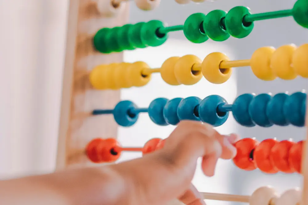 Child learning with a colourful abacus
