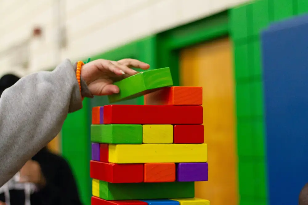 Child playing with colourful building blocks